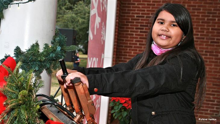 McAdenville Elementary second grader Ileny Zuniga was chosen to โflip the switchโ at the annual McAdenville tree lighting ceremony.